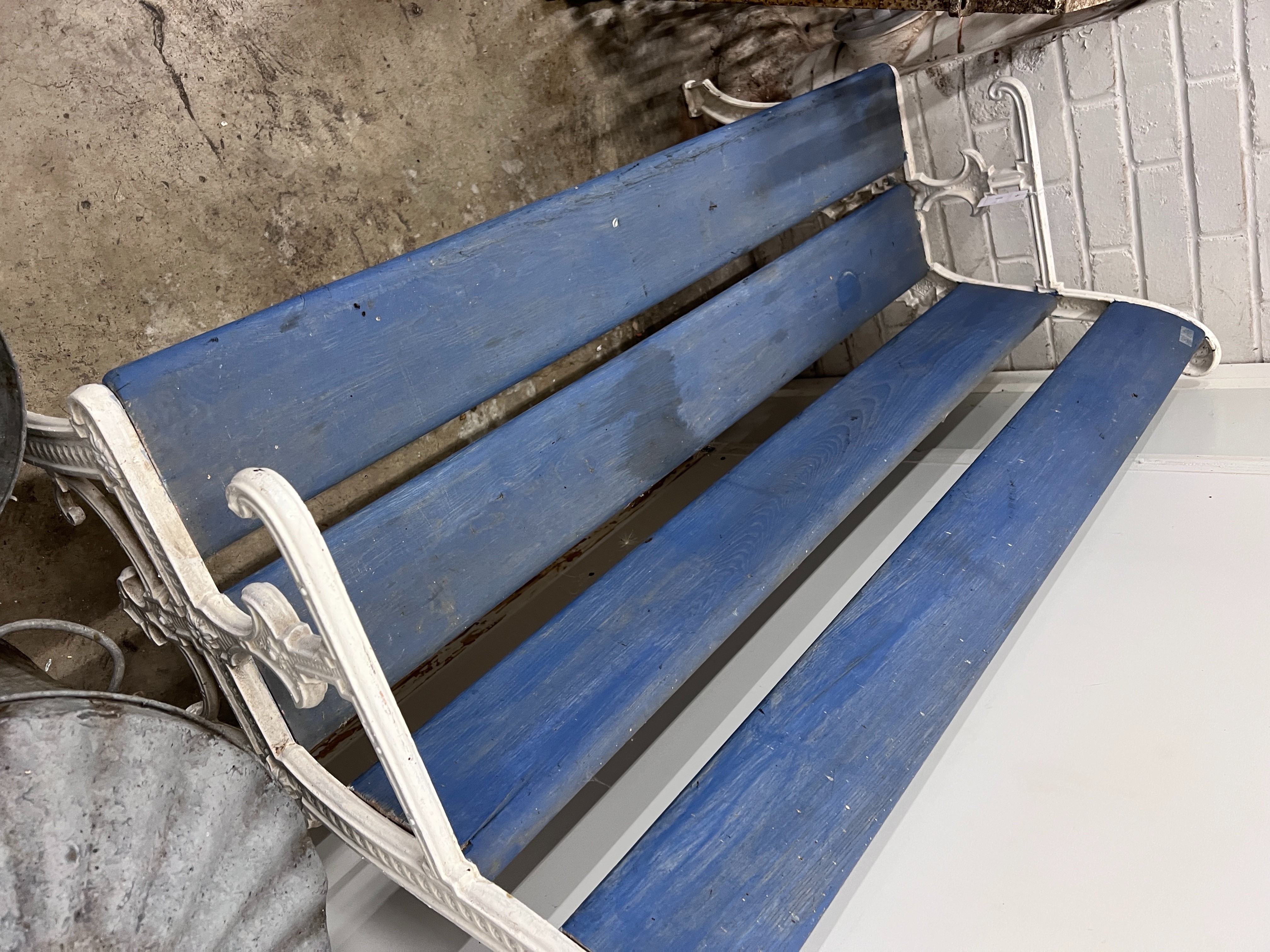 A Victorian style painted cast iron and wooden slatted garden bench, length 131cm, depth 54cm, height 84cm